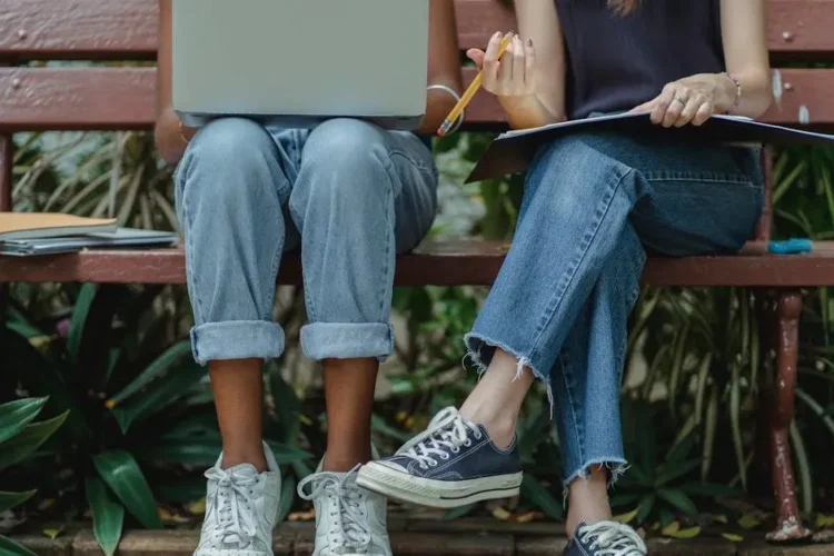 Students engaging in oral health education on a laptop outdoors