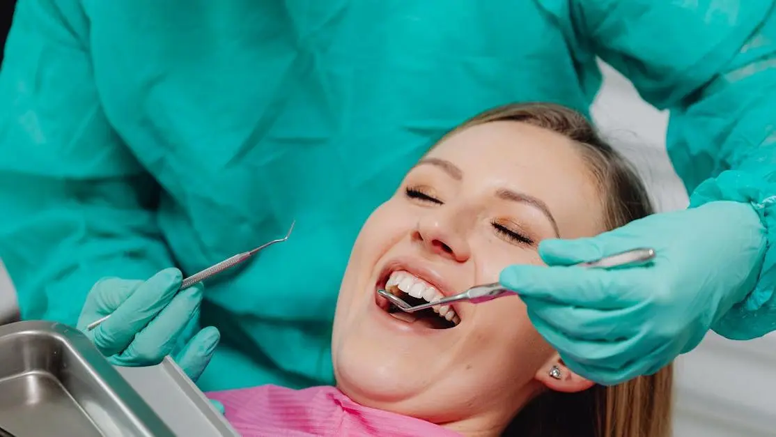 Woman smiling during pain-free dental checkup near me