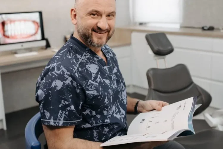 Dentist smiling, promoting pain-free dental visits.