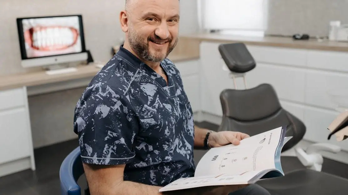 Dentist smiling, promoting pain-free dental visits.