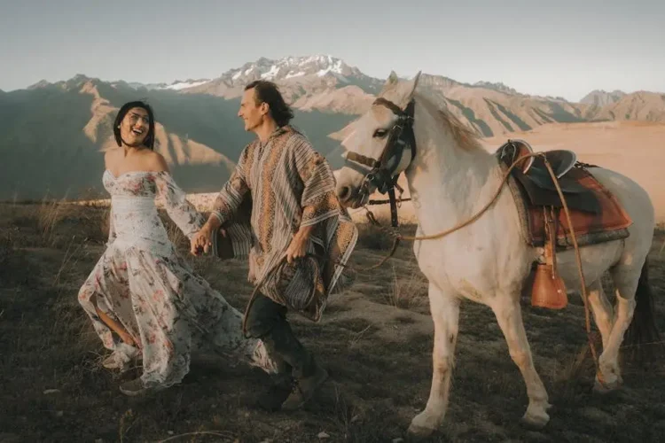 Happy couple showcasing pain-free root canals amidst scenic mountain backdrop.