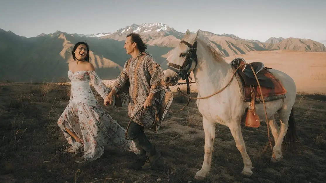 Happy couple showcasing pain-free root canals amidst scenic mountain backdrop.