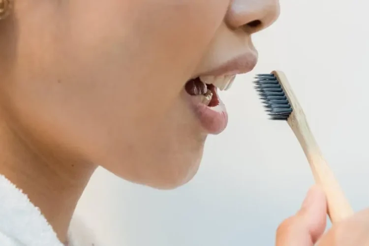 Close-up of a person enjoying pain-free teeth cleaning while brushing her teeth