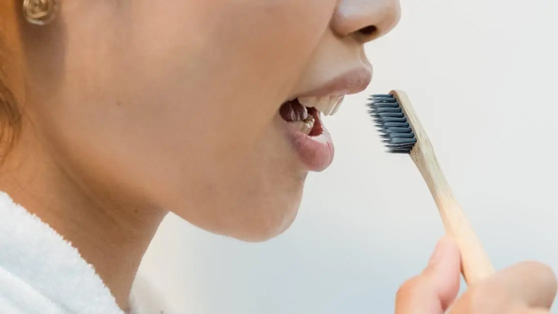 Close-up of a person enjoying pain-free teeth cleaning while brushing her teeth