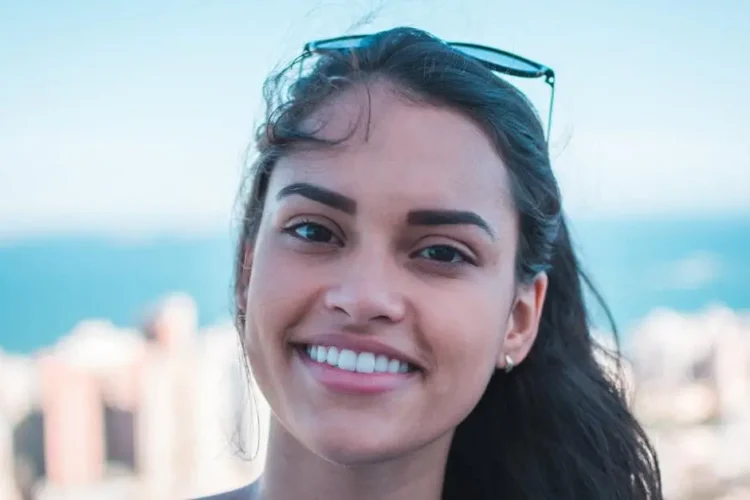 Smiling woman showcasing porcelain veneers procedure results