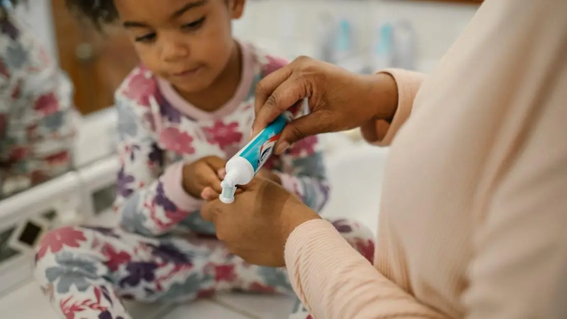 Mother preparing daughter for first dental visit, emphasizing dental care.