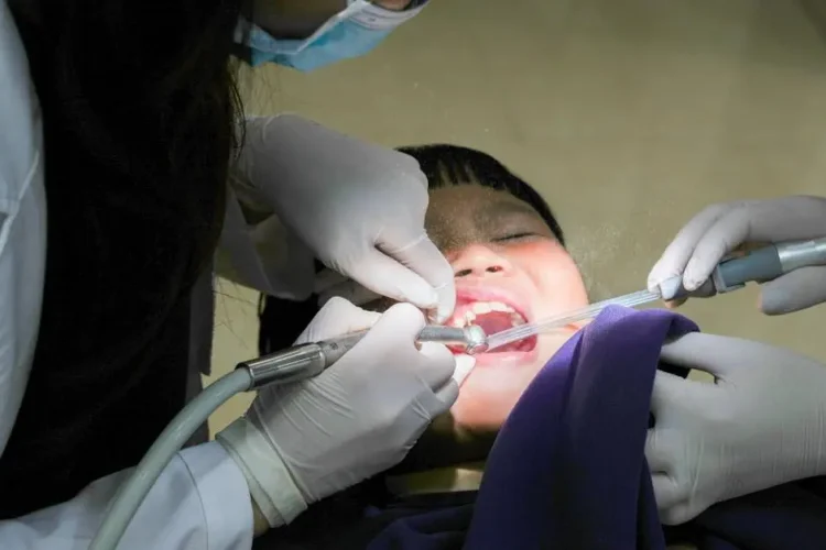 Child undergoing pulpotomy procedure