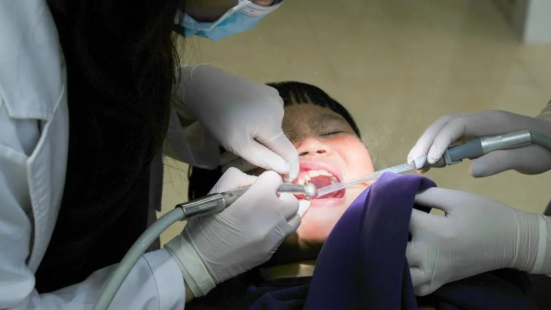 Child undergoing pulpotomy procedure