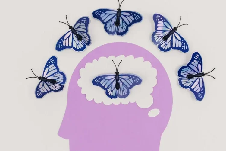 Visual representation of replacing missing teeth concept with butterflies symbolizing transformation