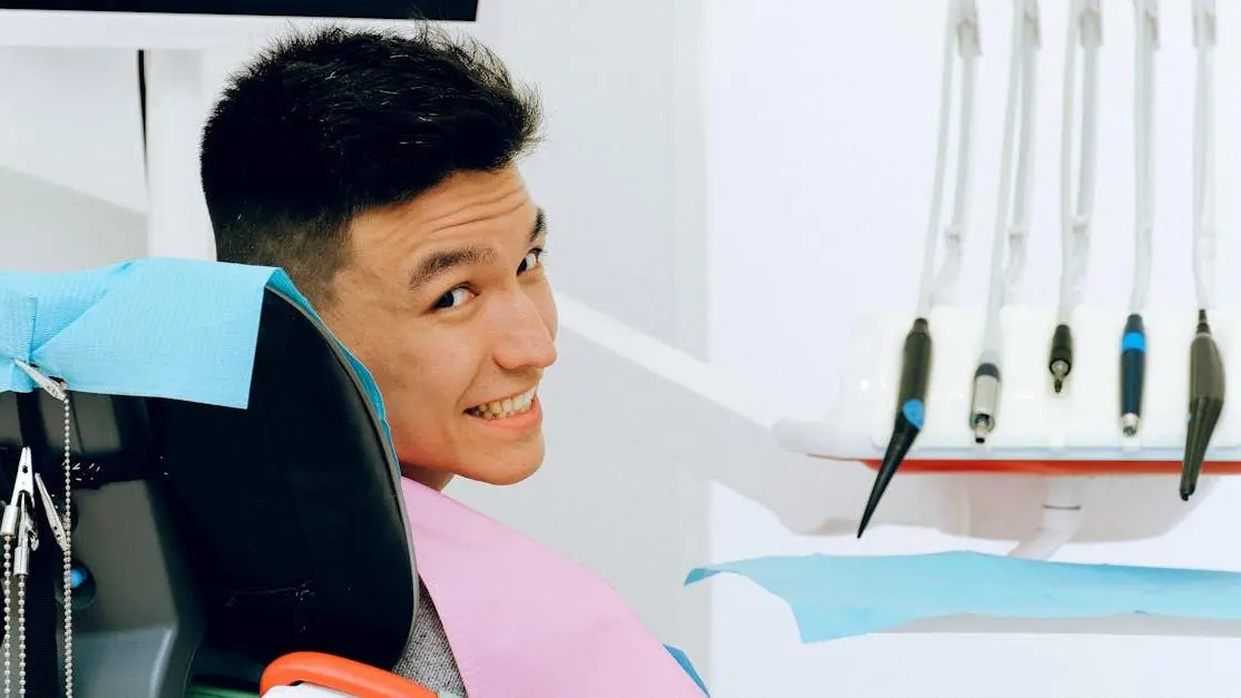 Smiling man in dental chair, preparing for treatment with safe deep sedation dentist