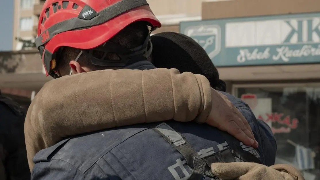 Emotional embrace after earthquake; illustrates urgency of same-day emergency dentists.