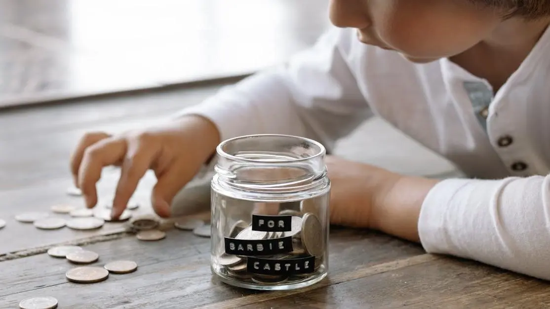 Child explores saving strategies using coins, highlighting ways to save money on dental care.