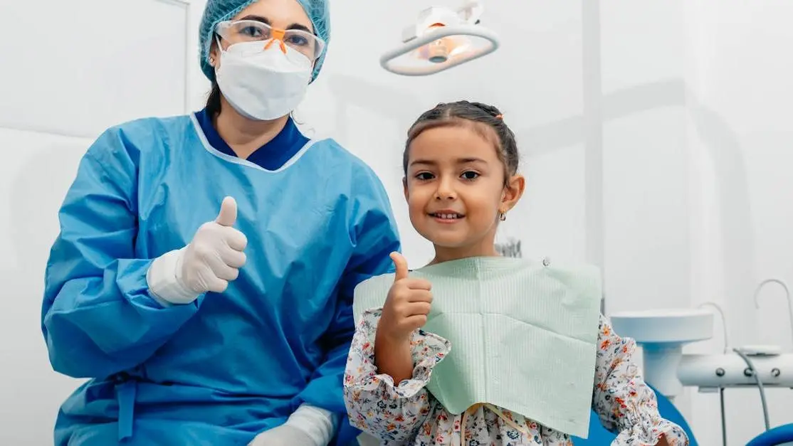 Dentist with child patient smiling, promoting sedation dentistry for kids