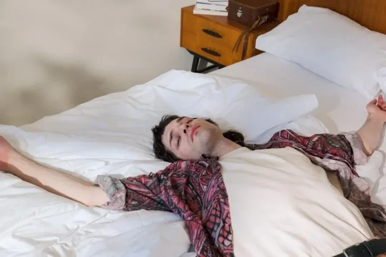 Young man in bed, illustrating sleep dentistry for sleep disorders.