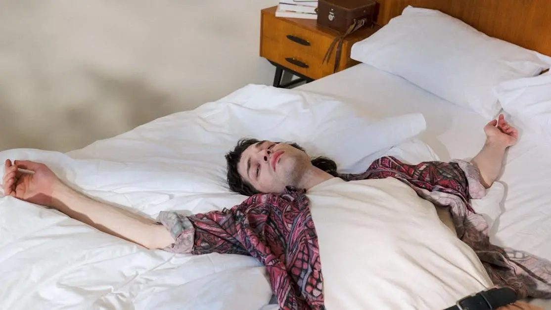 Young man in bed, illustrating sleep dentistry for sleep disorders.