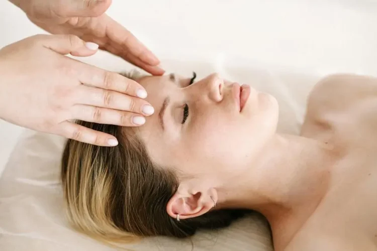 Woman receiving a massage to stop grinding teeth.