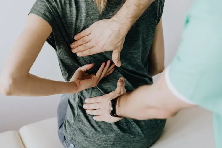 Dentist examines woman's teeth for grinding signs