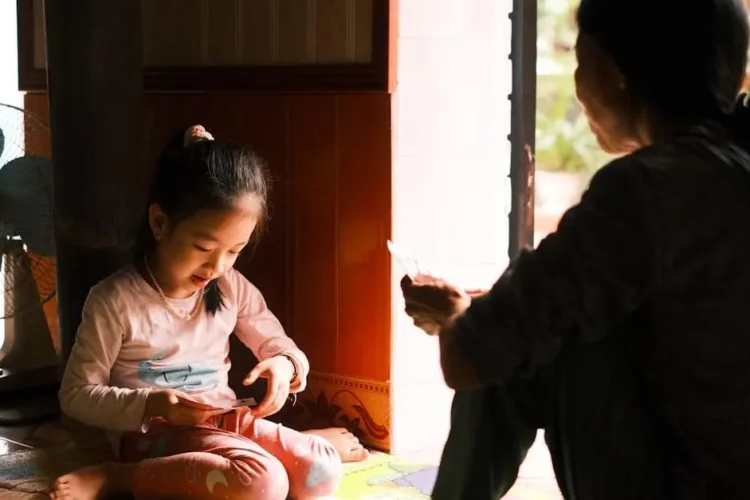 Mother and daughter bonding, the child is thumbsucking indoors