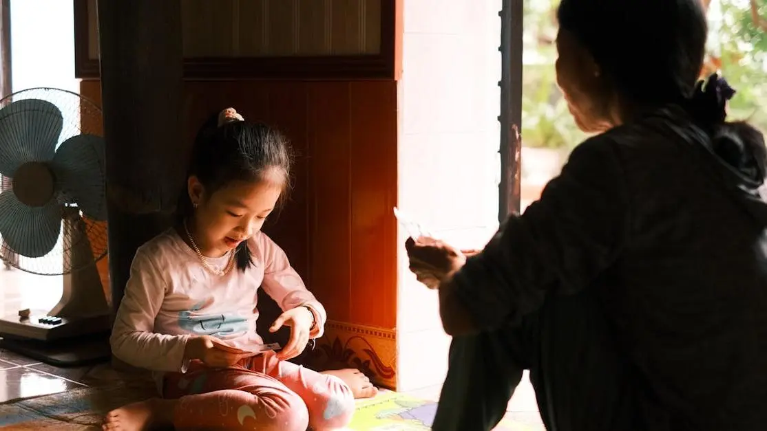 Mother and daughter bonding, the child is thumbsucking indoors