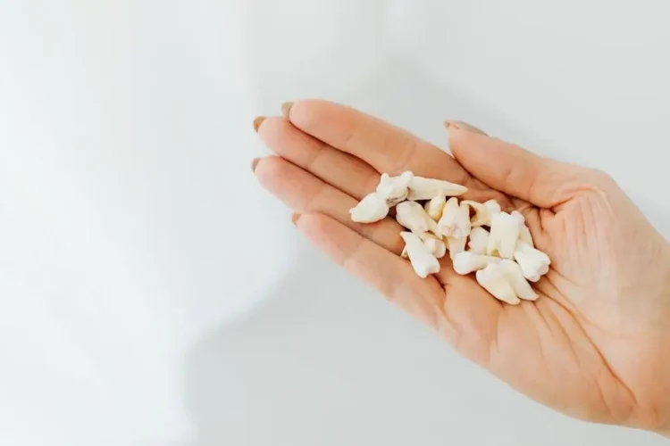 Hand holding a tooth after avulsion