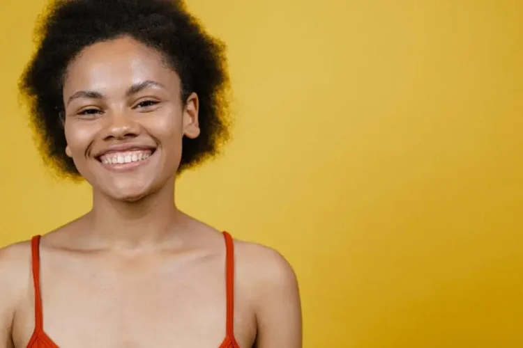 Smiling woman exploring tooth replacement options.