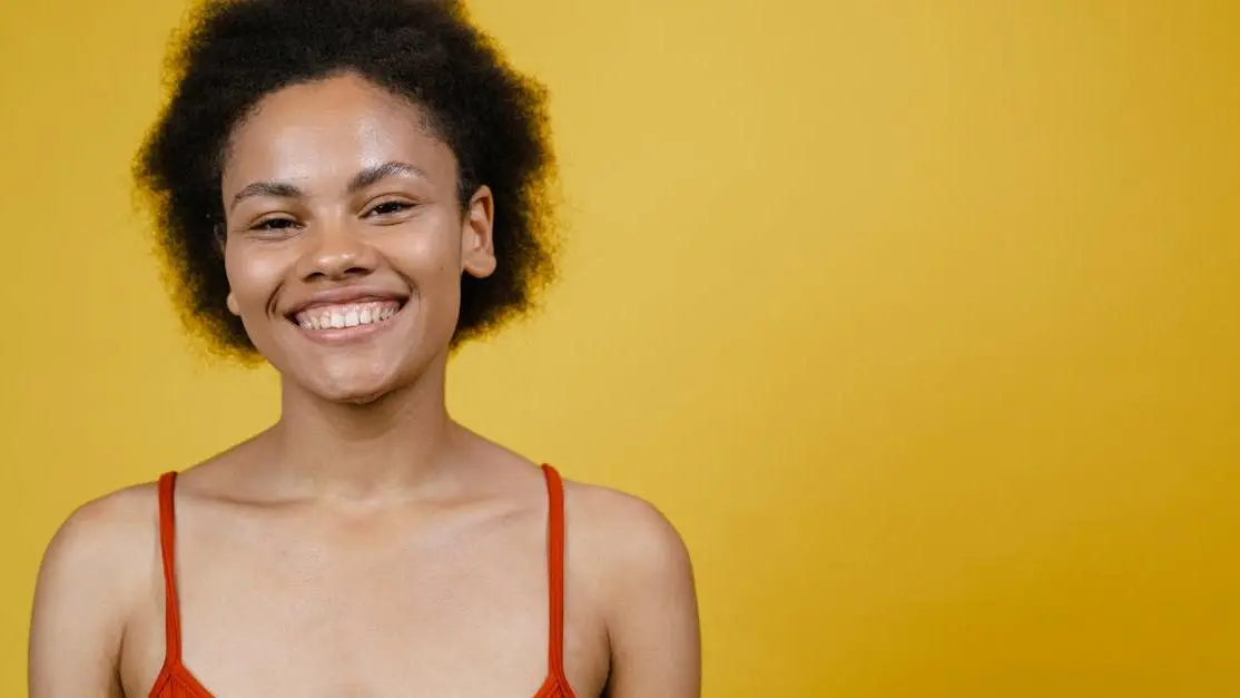 Smiling woman exploring tooth replacement options.