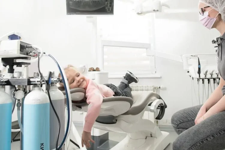 Child smiling at Kyiv dental clinic, showcasing affordable dental care near me.