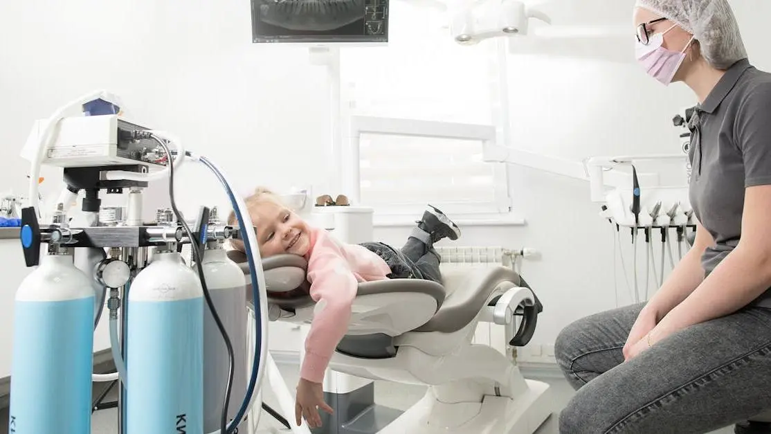 Child smiling at Kyiv dental clinic, showcasing affordable dental care near me.