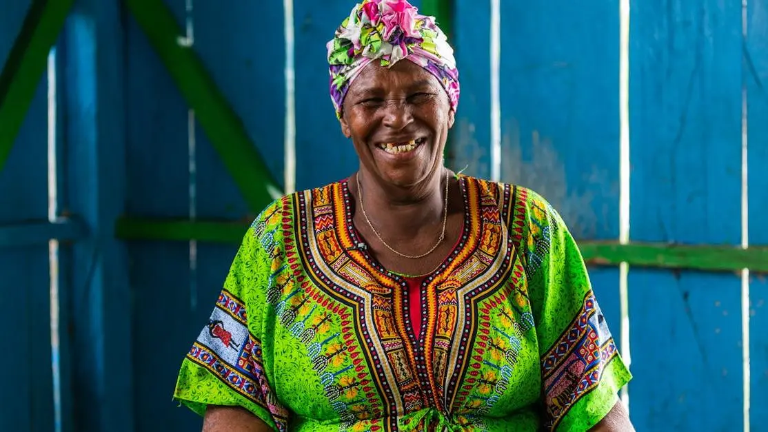 Smiling woman showcasing the benefits of dental implants.