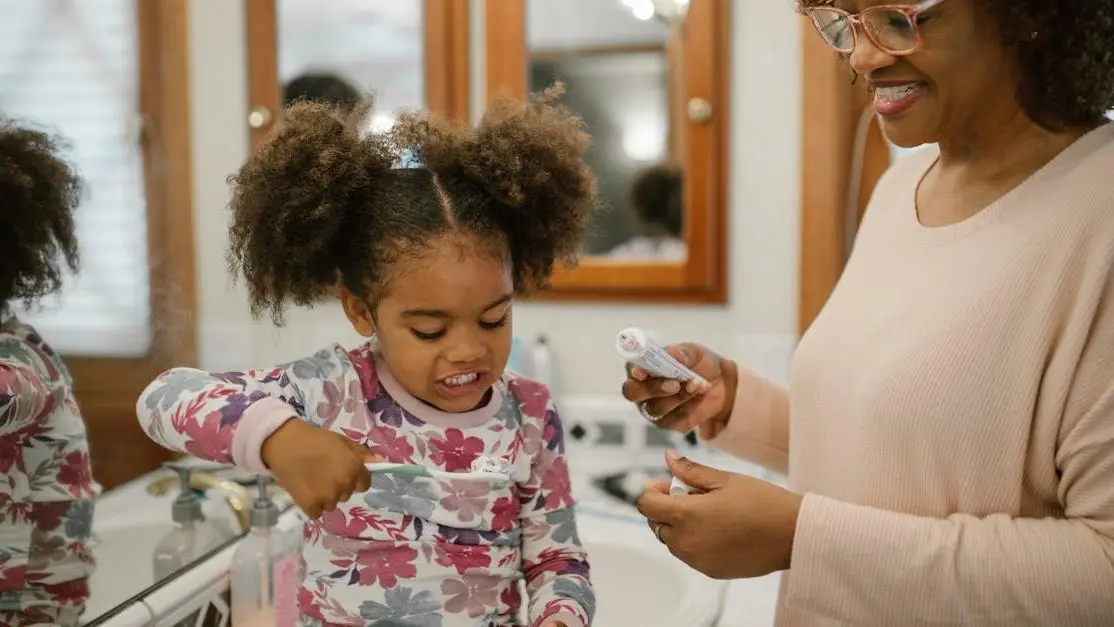 Mother and daughter practicing best dental care for kids during morning routine.