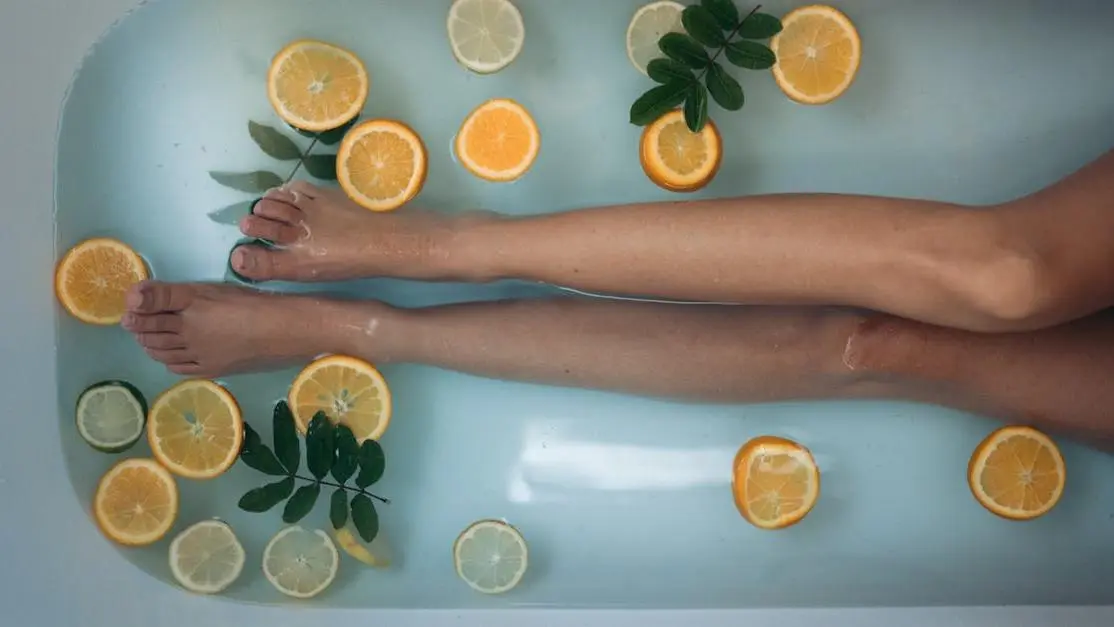 Hand holding sliced orange, related to canker sores.