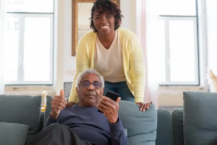 Senior man and caregiver smiling, highlighting caregivers dental health.