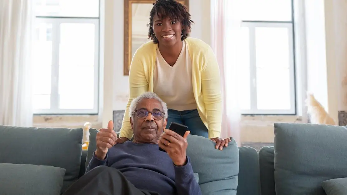 Senior man and caregiver smiling, highlighting caregivers dental health.