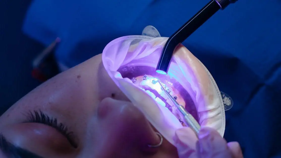 Patient receiving dental treatment with clear braces