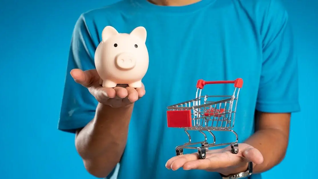 Savings vs. spending concept for the cost of cosmetic dental procedures, with piggy bank and mini shopping cart.