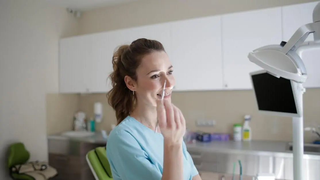 Cheerful dental professional in modern clinic, illustrating Cost of dental implants concept.