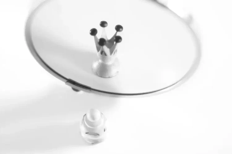 Pawn reflecting as a crown, symbolizing self-perception and crown lengthening concept.