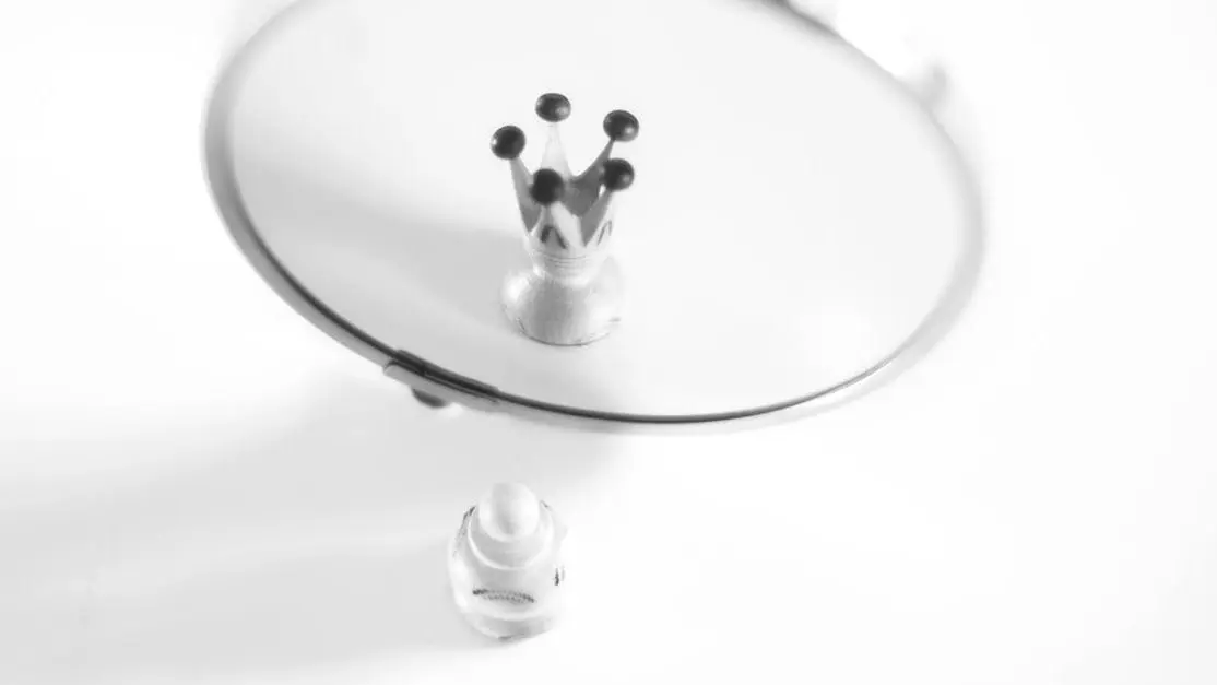 Pawn reflecting as a crown, symbolizing self-perception and crown lengthening concept.