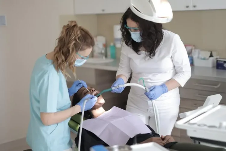 Female dentist treating patient, highlighting dental careers at a modern clinic.