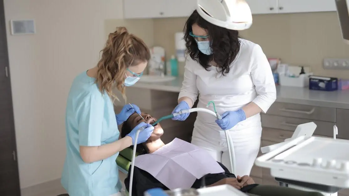 Female dentist treating patient, highlighting dental careers at a modern clinic.