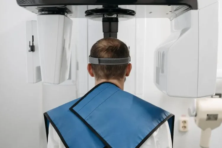 Man receiving panoramic dental x-ray, showcasing modern technology, focused on x-rays safety.