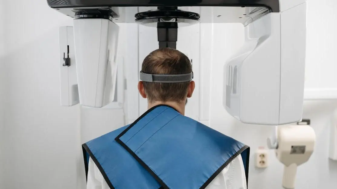 Man receiving panoramic dental x-ray, showcasing modern technology, focused on x-rays safety.