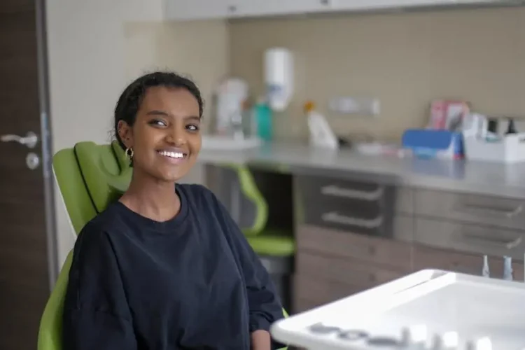 Cheerful woman enjoying a relaxed visit at a family-friendly dental service.