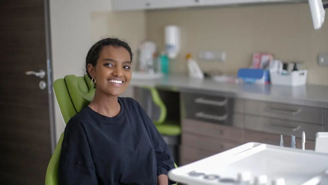 Cheerful woman enjoying a relaxed visit at a family-friendly dental service.