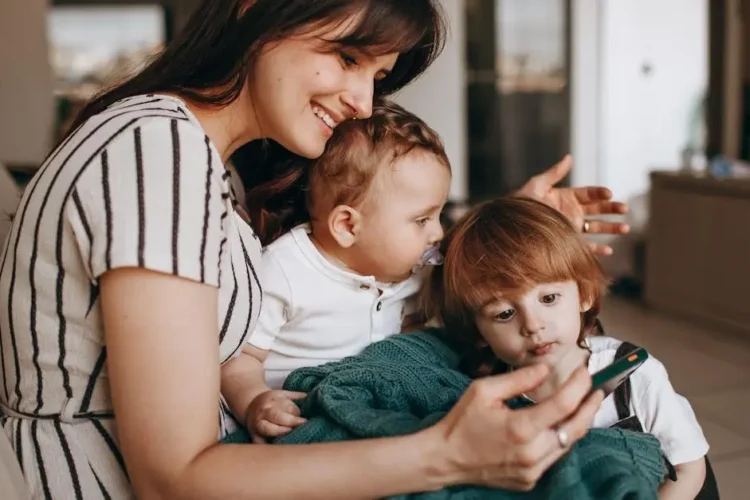 Smiling family with mother and two sons, illustrating finding a family dentist for all ages.