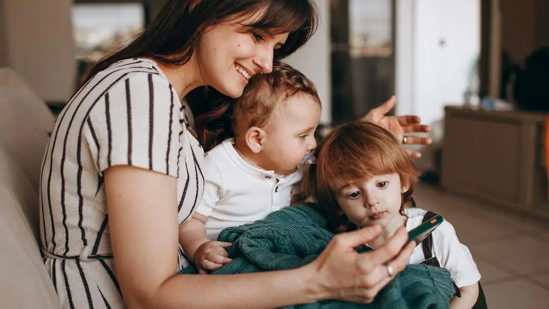 Smiling family with mother and two sons, illustrating finding a family dentist for all ages.