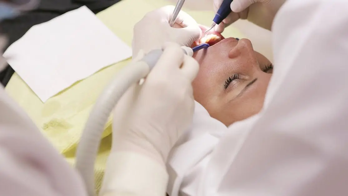 Dentist flossing teeth of a patient in a dental clinic