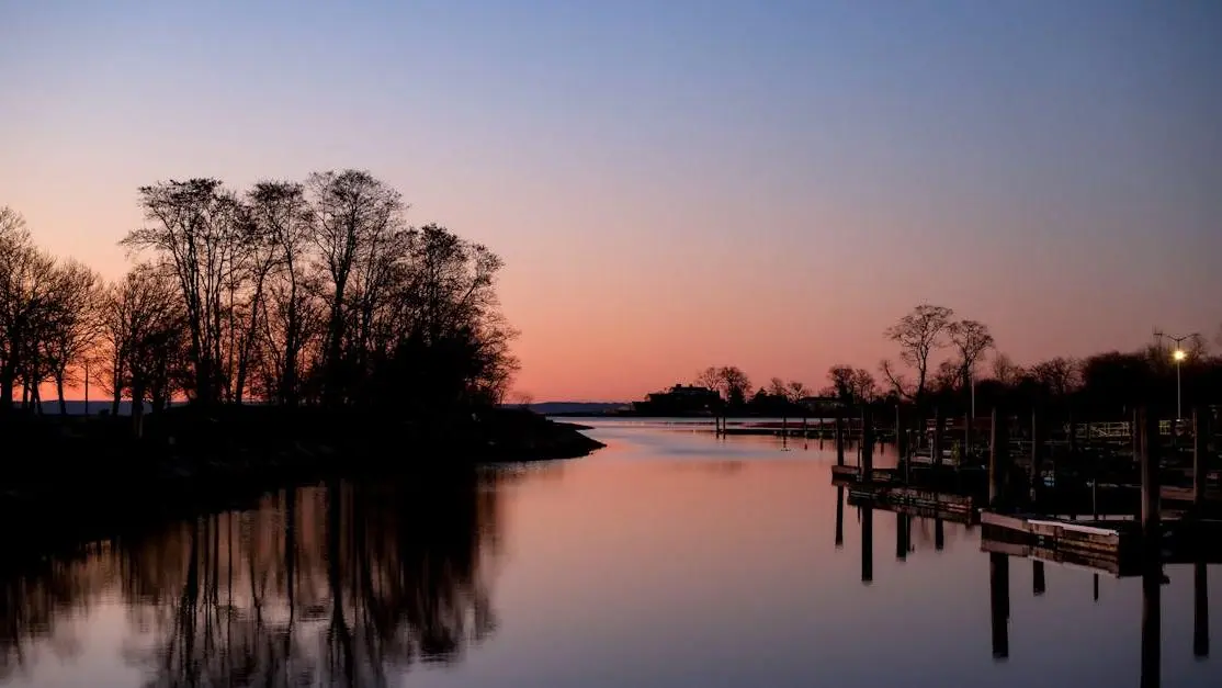 Sunset over Cove Island Park river with a wooden pier, illustrating fluoride safety context.