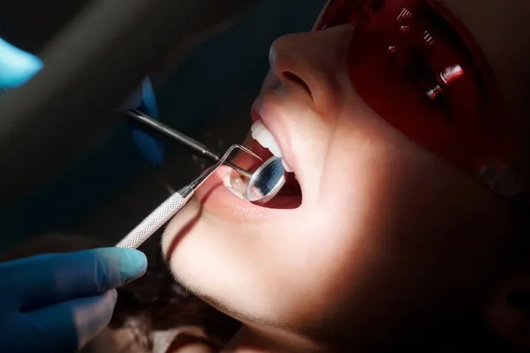 Dentist examining patient for signs of fluorosis