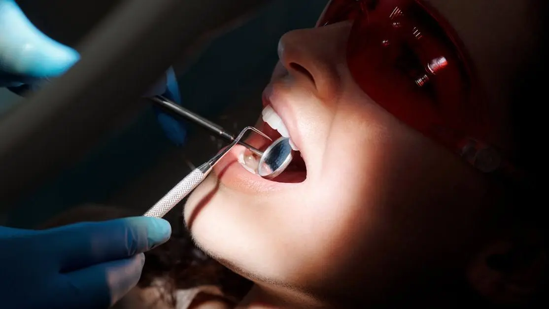 Dentist examining patient for signs of fluorosis